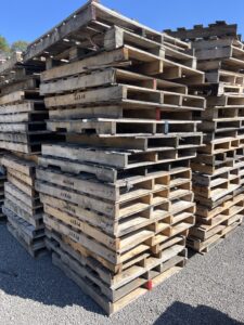 Stacks of used wooden pallets at Troymill facility awaiting recycling and reuse.
