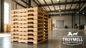 Neat stack of new blonde wood pallets in a clean industrial warehouse from a reliable pallet supplier