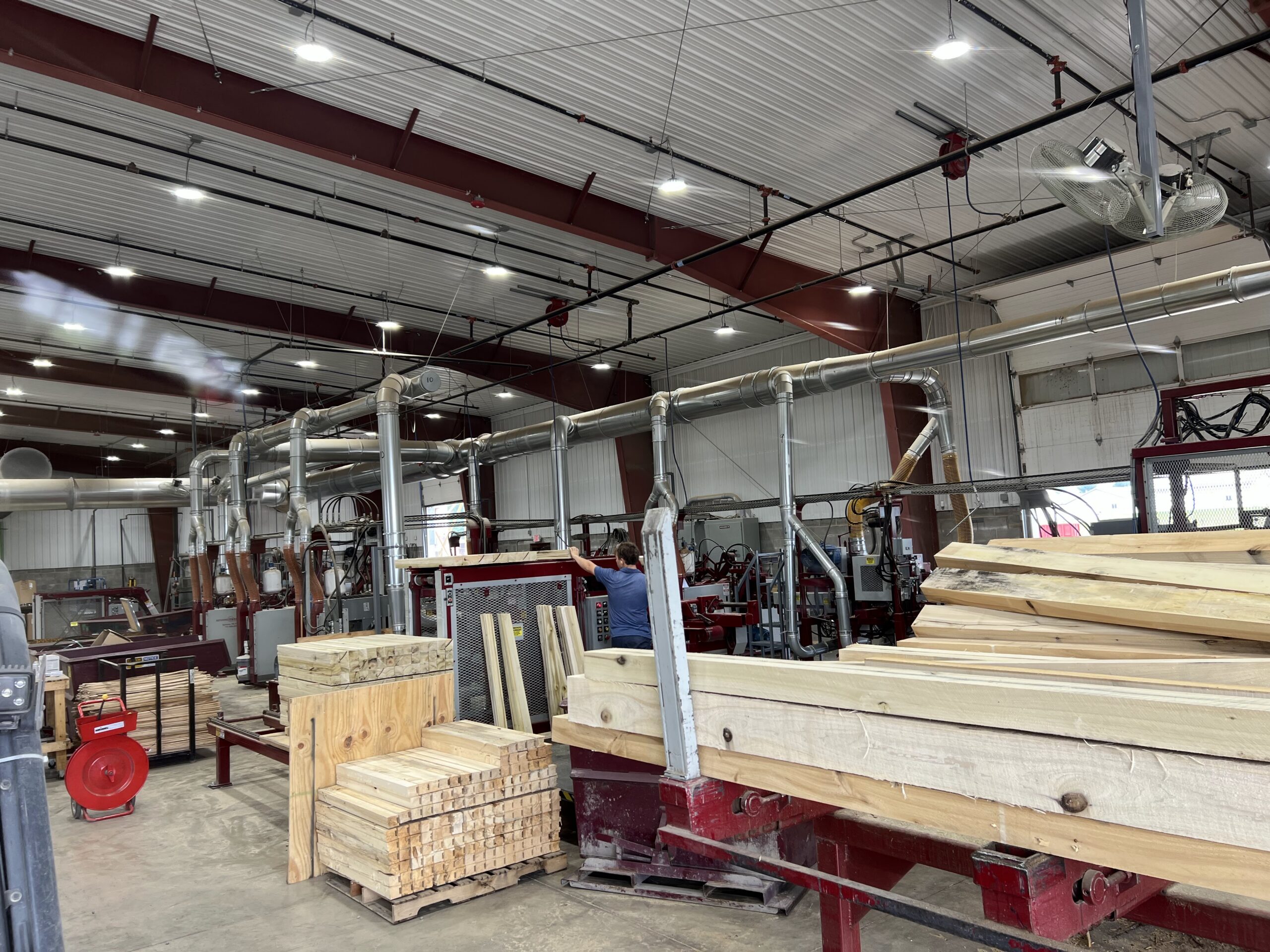 Overhead dust collection ductwork above Troymill's new saw line at the Middlefield campus